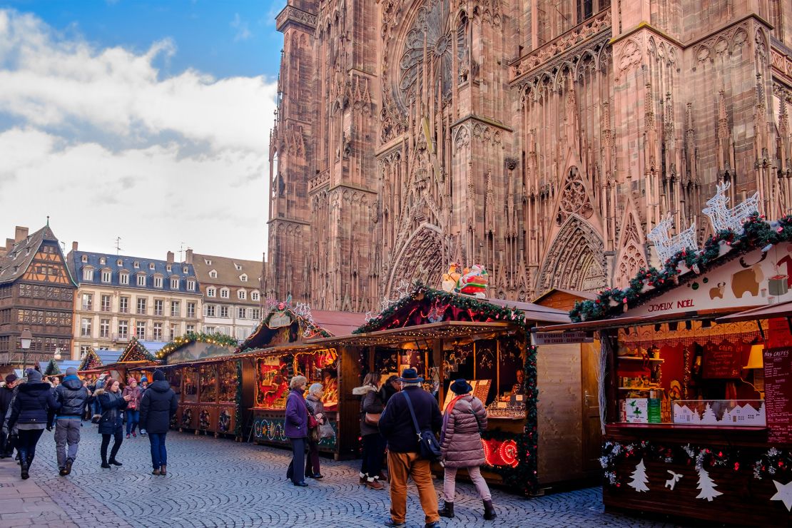 People stroll among the stalls at the Christmas market in Place de la Cathédrale in Strasbourg, France. The market opens on November 27 this year.