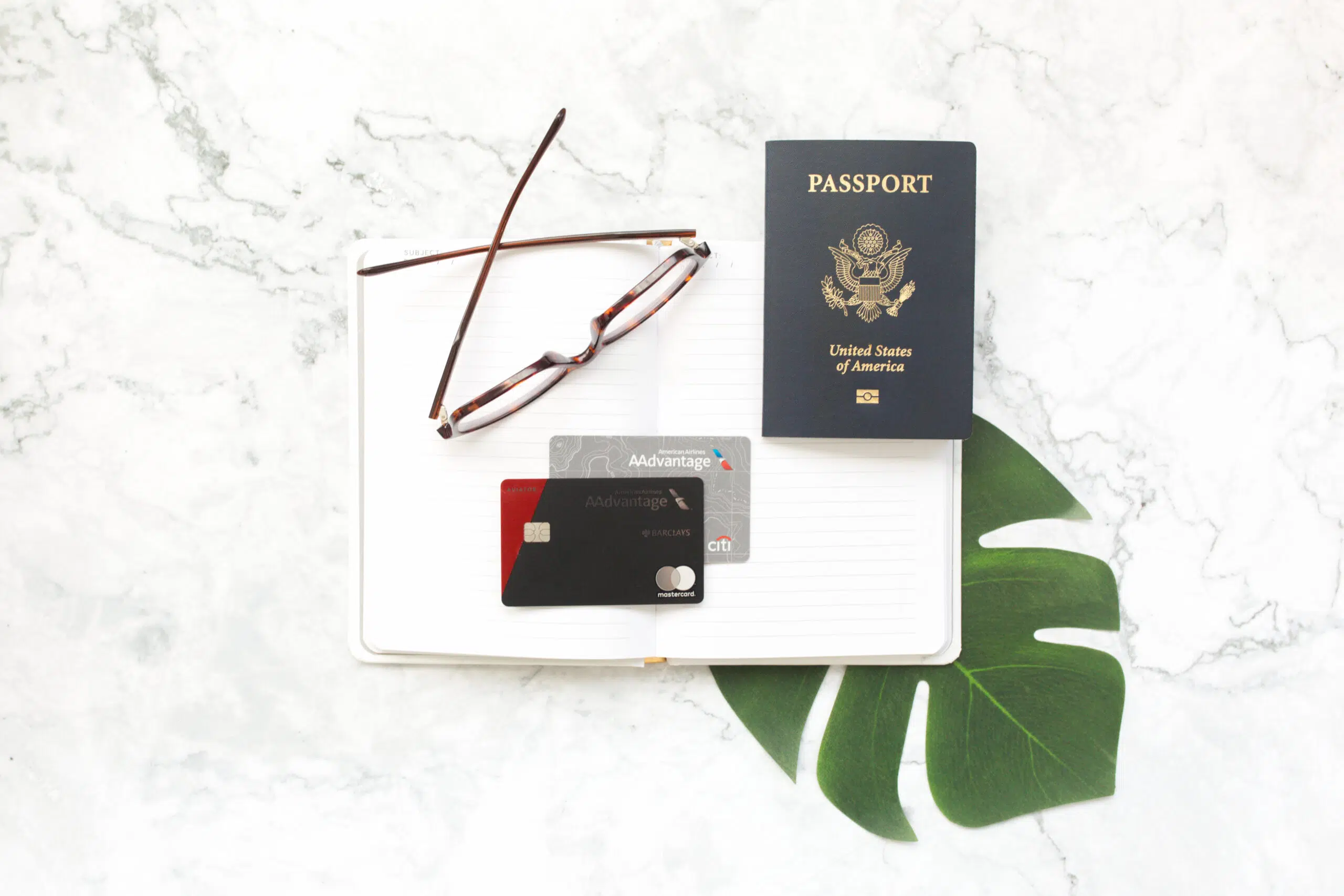 American Airlines credit cards with a passport and glasses