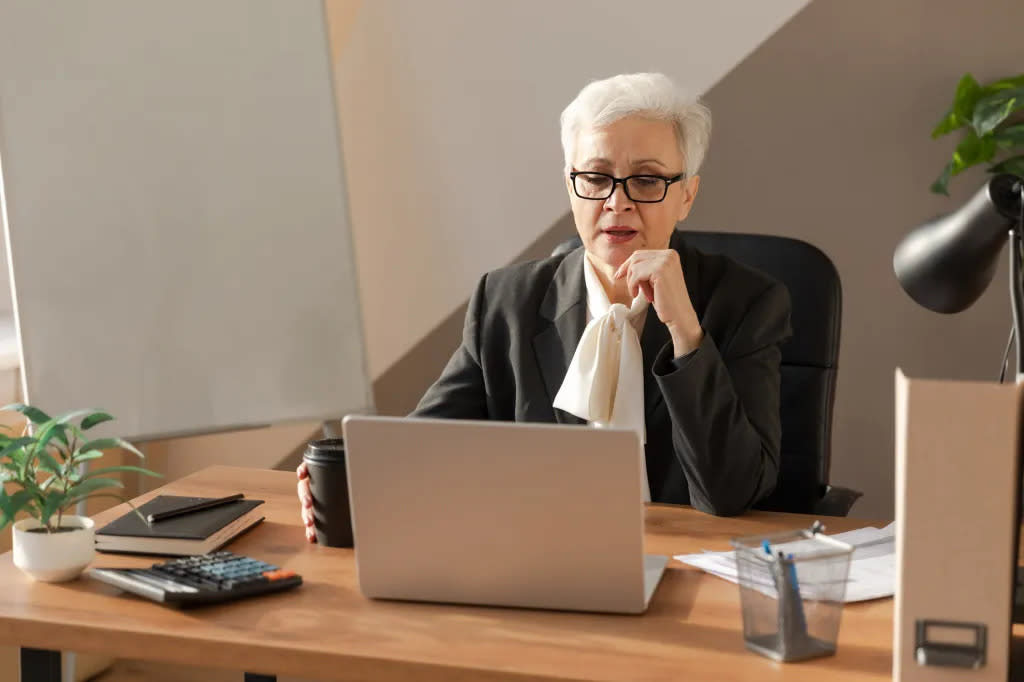 A business woman researching Roth IRA tax rules for overseas citizens.