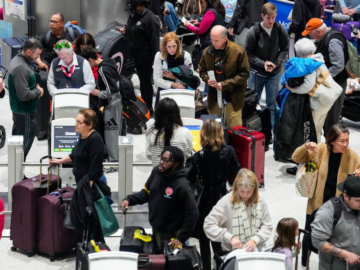 Passengers use the check-in kiosks as they make their way through the C Terminal at George Bush Intercontinental Airport on Thursday, December 21, 2023, in Houston.