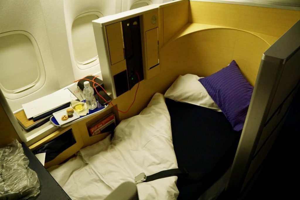 ANA first class seat in lie flat mode with the bed made.