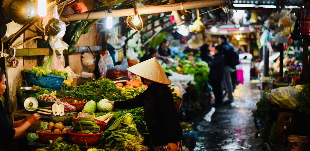 Vietnam market, local and fresh fruit and veg displayed on stalls 