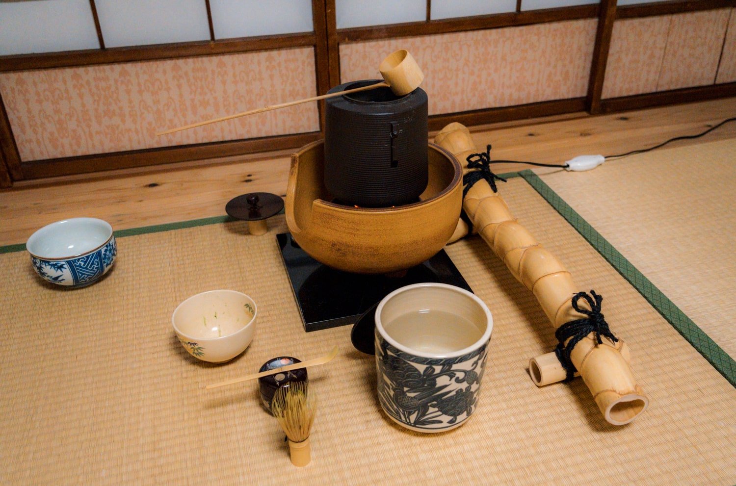 Japanese tea ceremony tools including bamboo ladels and kettle.