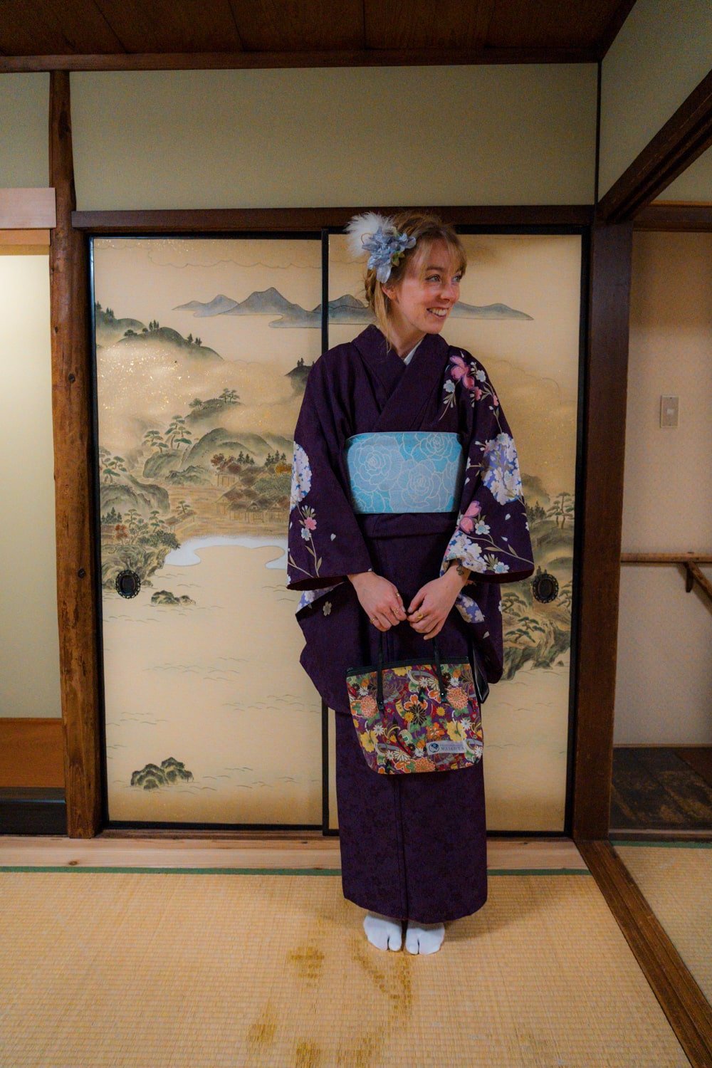 Bucketlist Bri travel blogger wearing a purple kimono at Maikoya tea school in Kyoto, Japan.