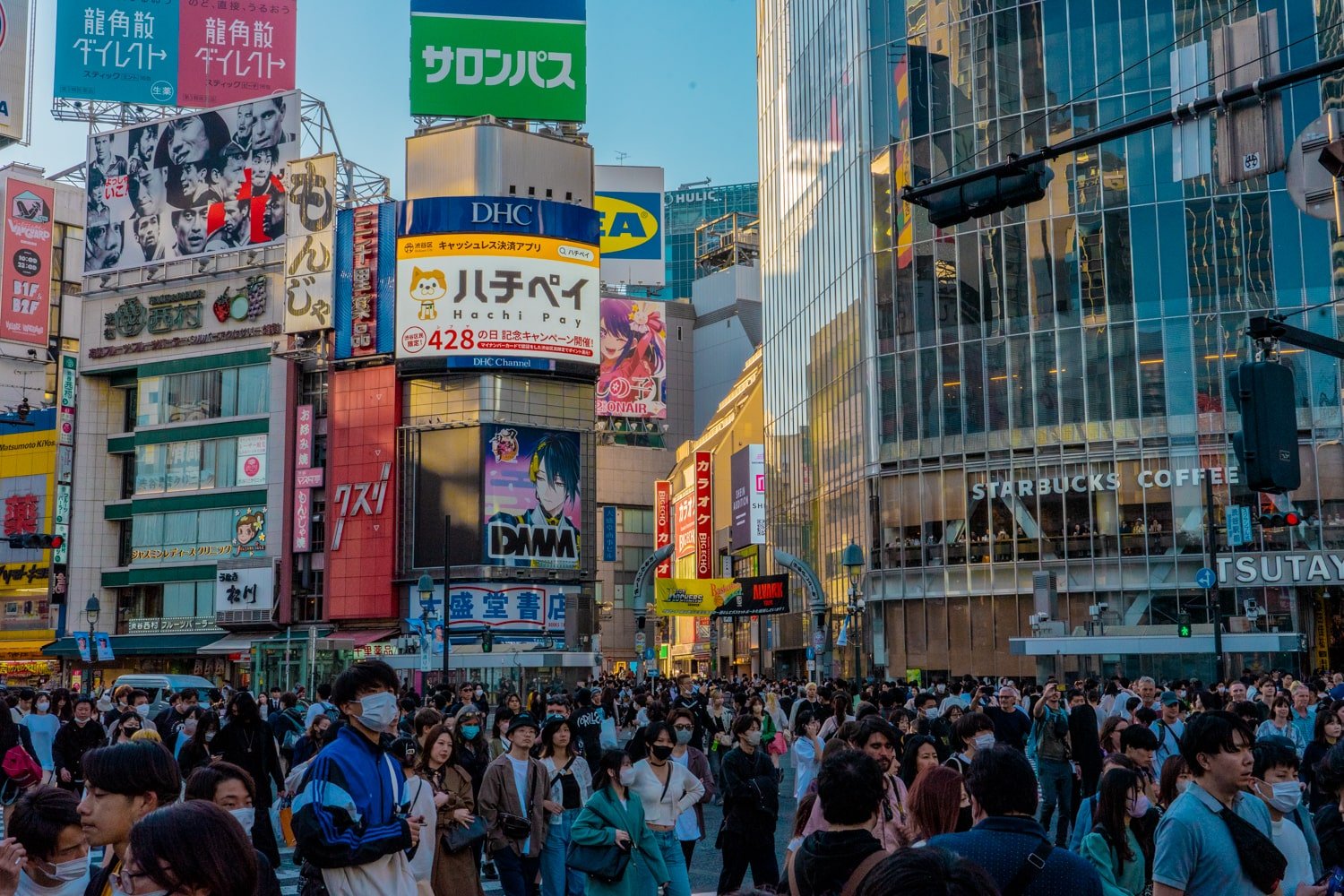 Sunset crowds crossing the world's largest pedestrian crossing at Shibuya Scramble Crossing in Tokyo, Japan.