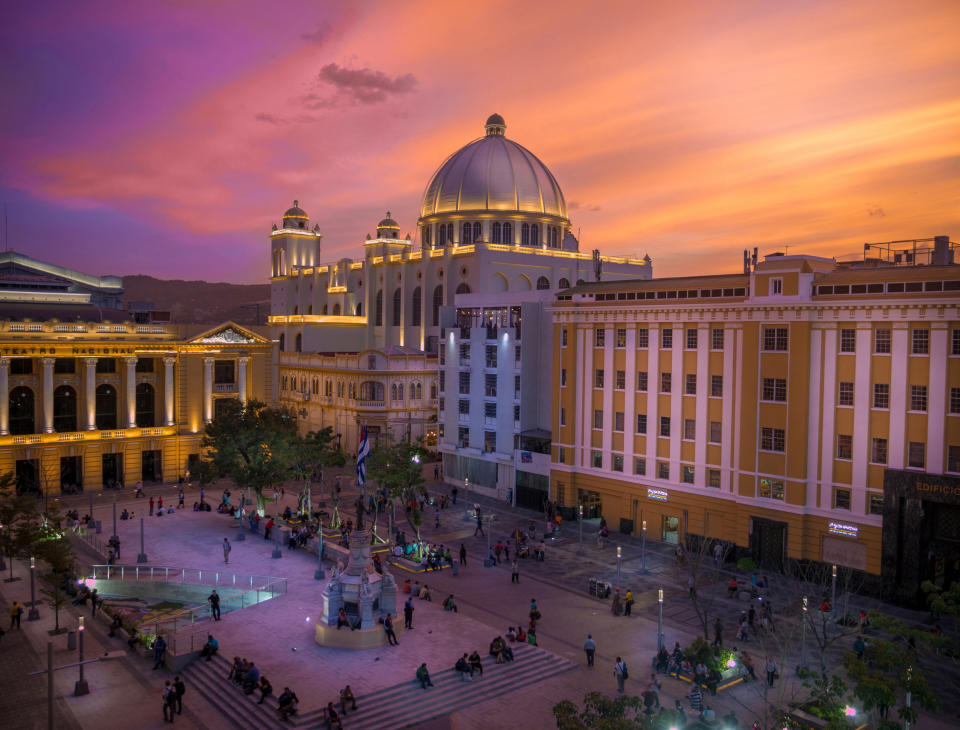 A bustling town square at sunset in El Salvador.