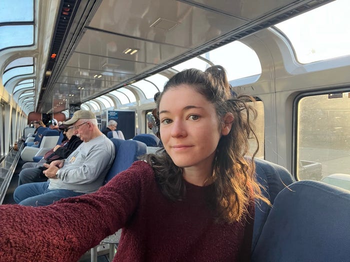 diana taking a selfie in the observation car of an amtrak train