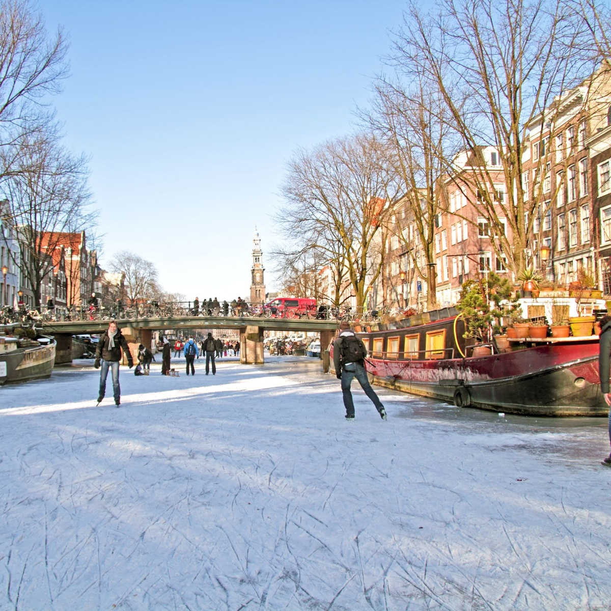 Ice skating on the canals in Amsterdam the Netherlands in winter
