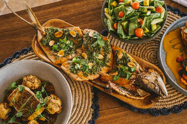 A full array of Colombian food including fried fish and salad. 