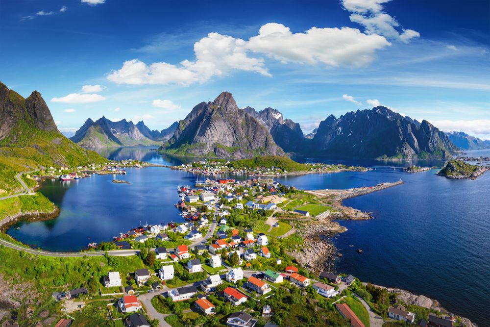 Reine, Lofoten, Norway. The village of Reine under a sunny, blue sky, with the typical rorbu houses. View from the top