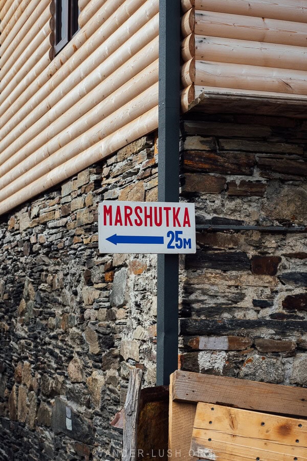 A sign points the way towards marshrutka vans in Ushguli.