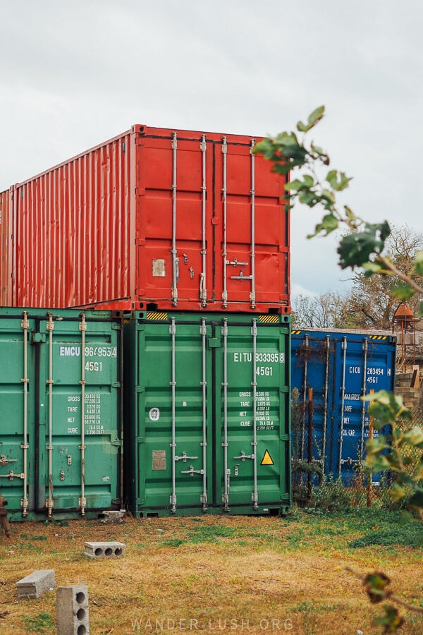 Brightly coloured shipping containers stacked in a garden in Poti, Georgia.