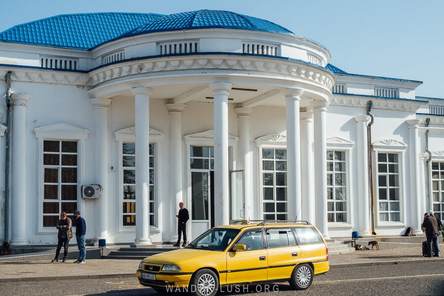 A taxi waits in front of the grand Poti Railway Station.