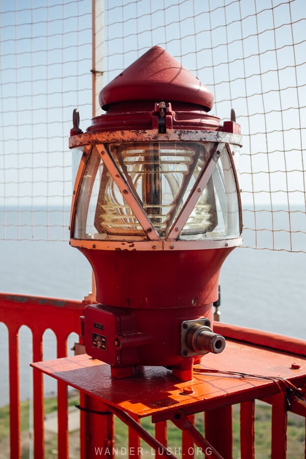 A beacon light at Poti Lighthouse with a view of the Black Sea.