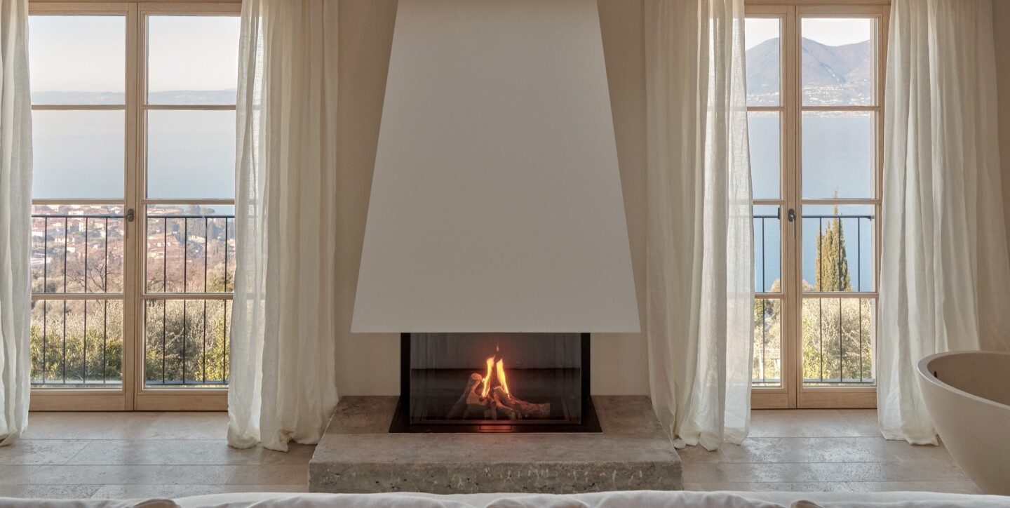 A guest room at Borgo Tre with a fireplace and French doors