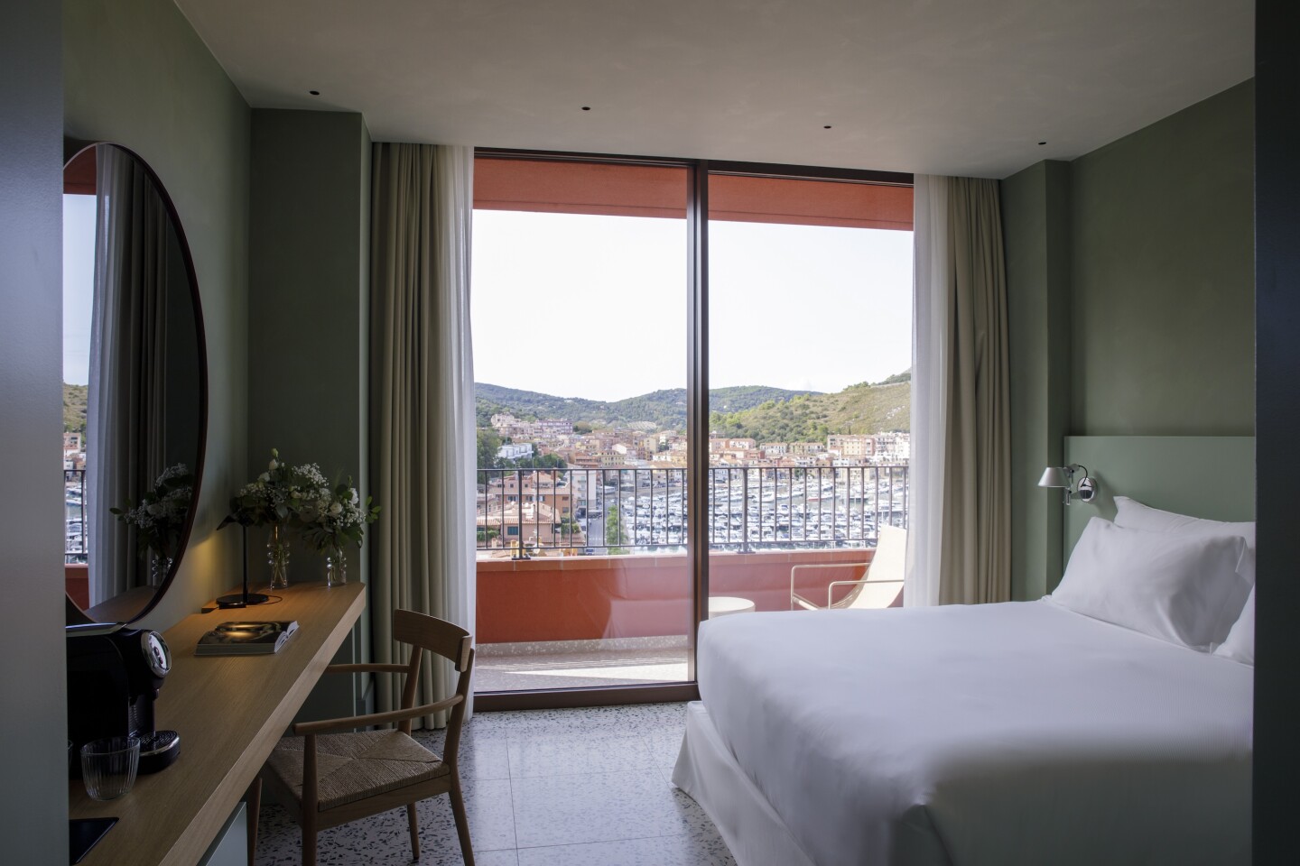 A guest room at La Roqqa in Porto Ercole with marina views