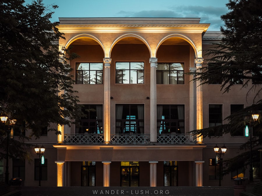 Restaurant Funicular in Tbilisi, a beautiful Soviet-era building illuminated at night.