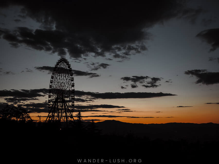 The sun sets over the Tbilisi Ferris Wheel on Mtatsminda.