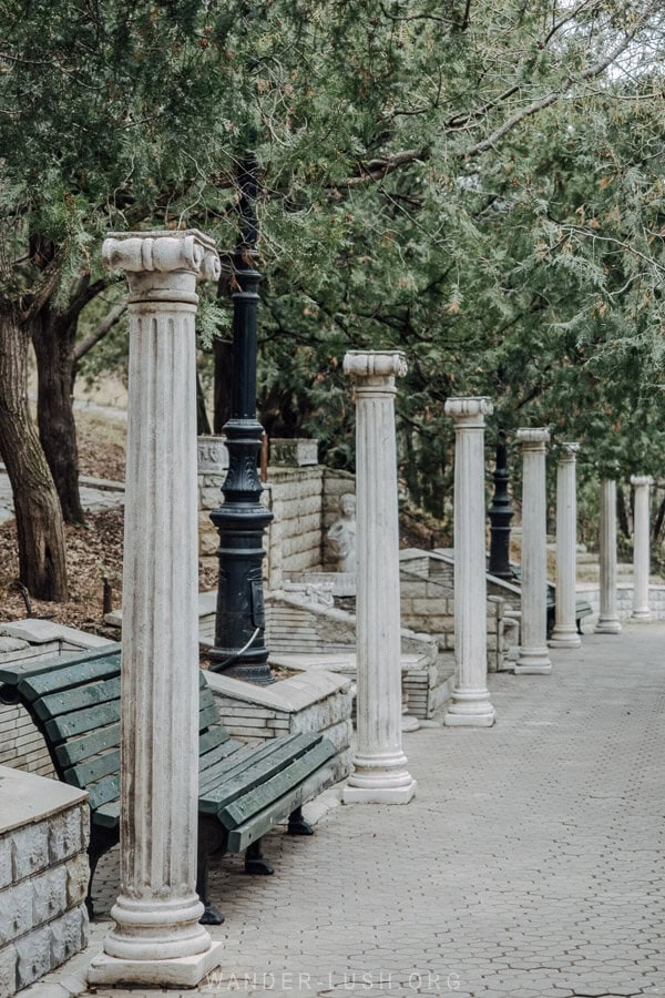 A row of white columns line a walking path in Mtatsminda Park, Tbilisi.