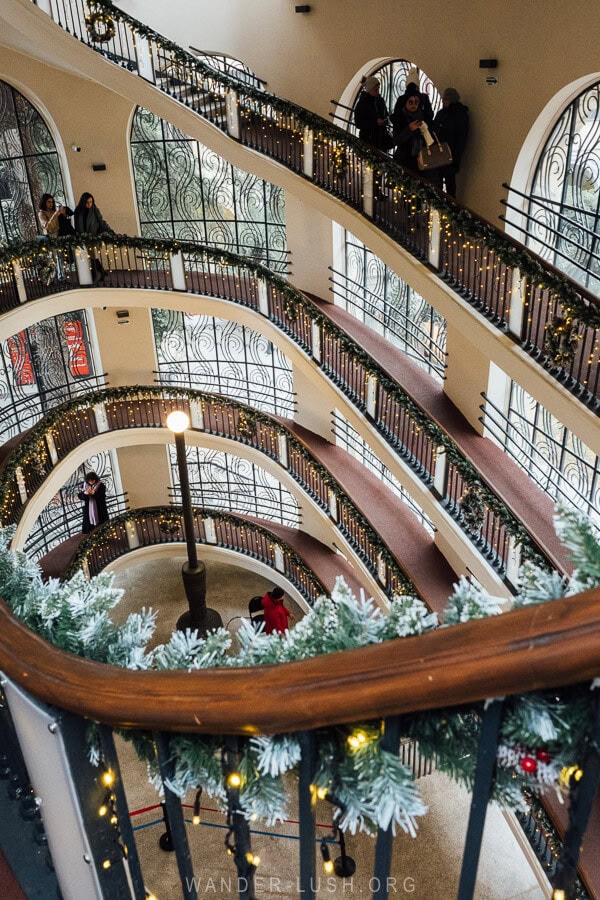 Two spiral staircases decorated with Christmas wreaths inside the restored Mtatsminda Cable Car station in Tbilisi.