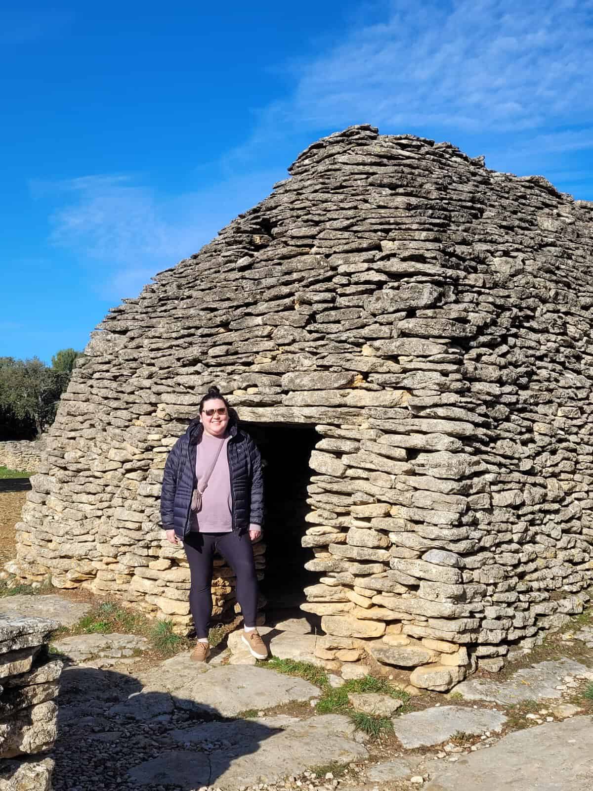 Riana standing in front of a Bories house in the Bories Village outside Gordes, France