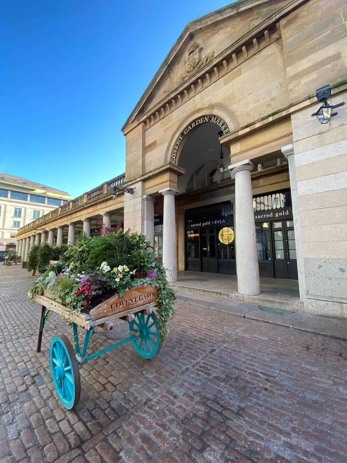 wagon with flowers outside of covent garden, london