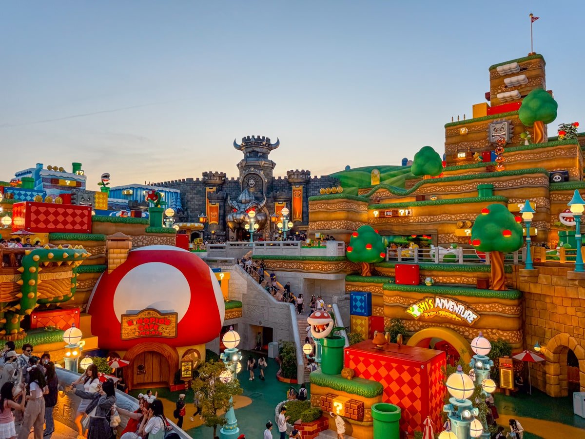 The Mushroom Kingdom at Super Nintendo World Japan lit up at night.