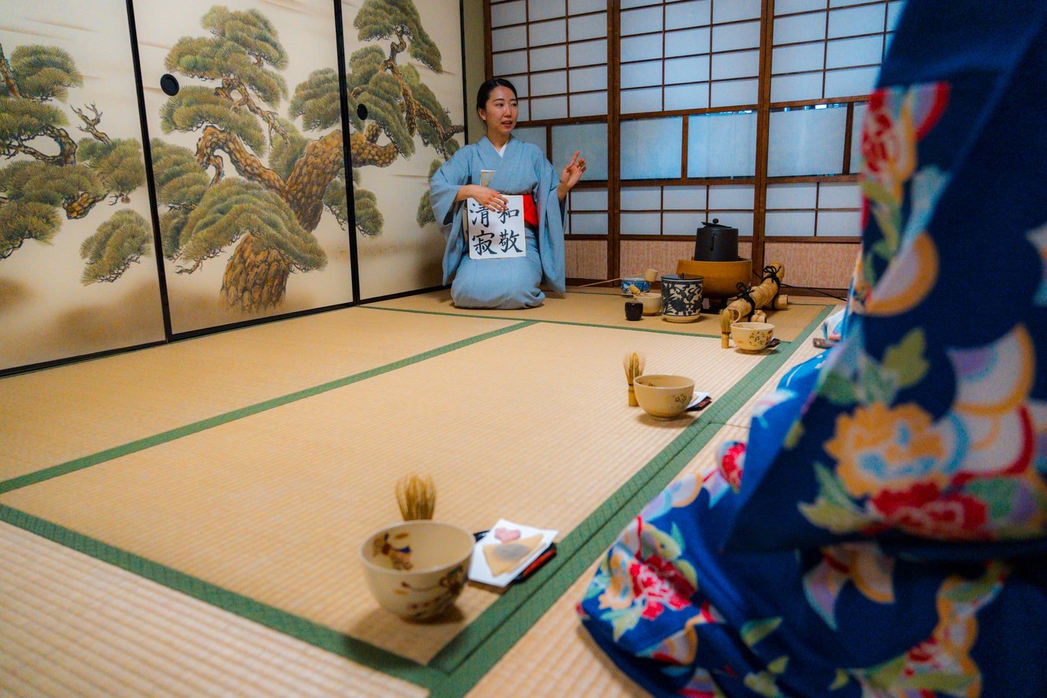 Japanese tea master wearing kimono performing tea ceremony at Maikoya school in Kyoto.