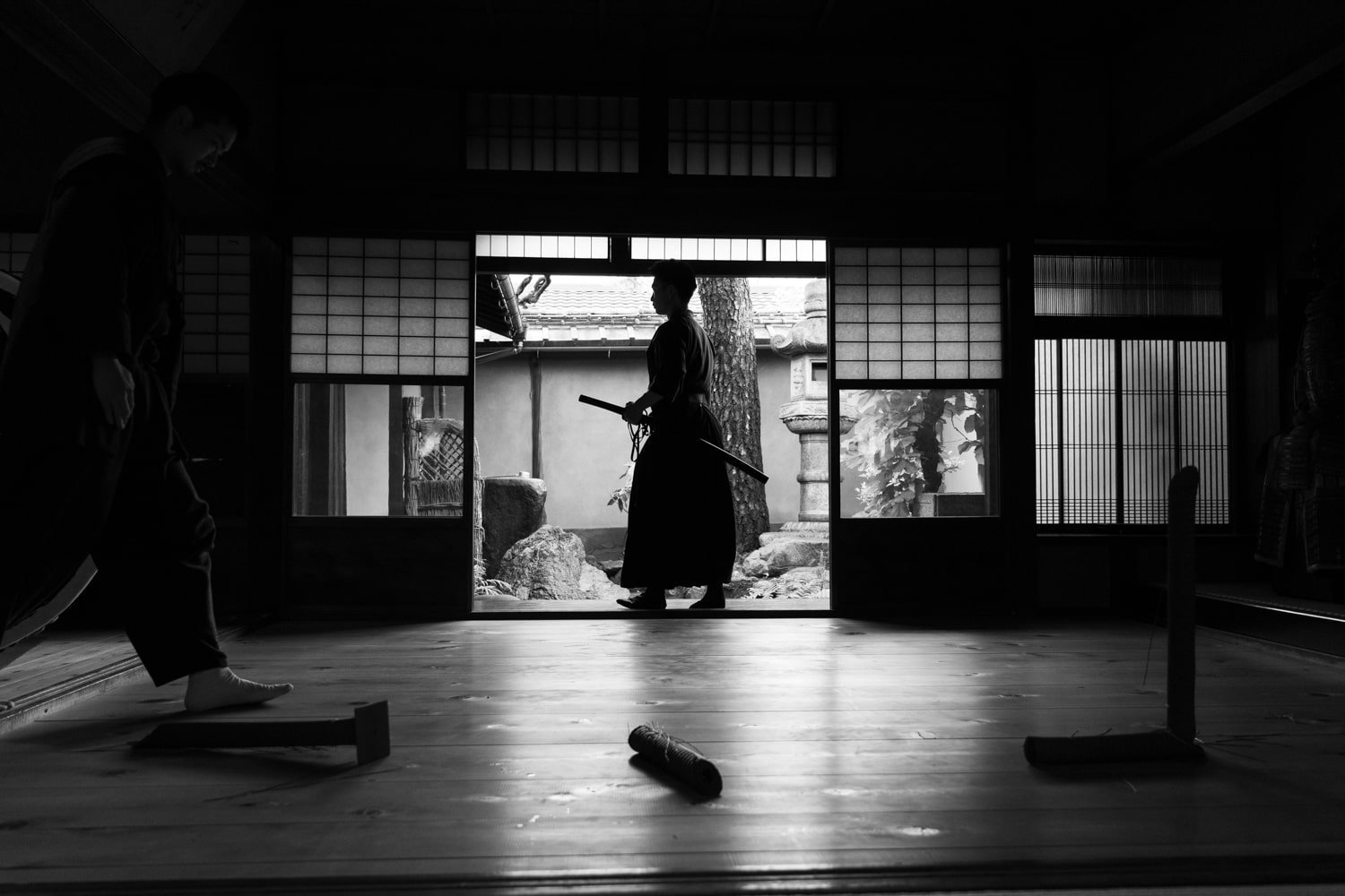 A black and white photo of a samurai katana demonstration inside a 250-year-old historic samurai's home.