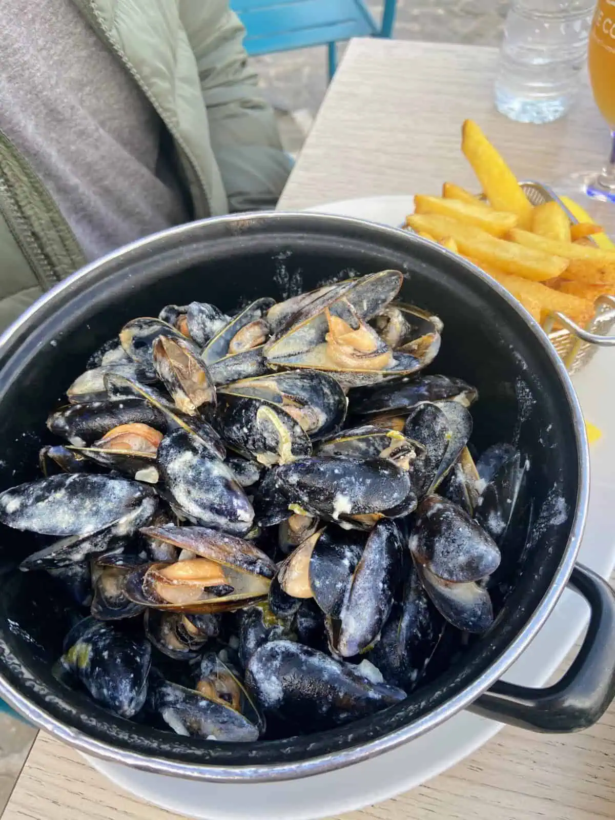 Fresh local mussels in a big bowl with a side of fries, enjoyed in Villefranche sur Mer, France