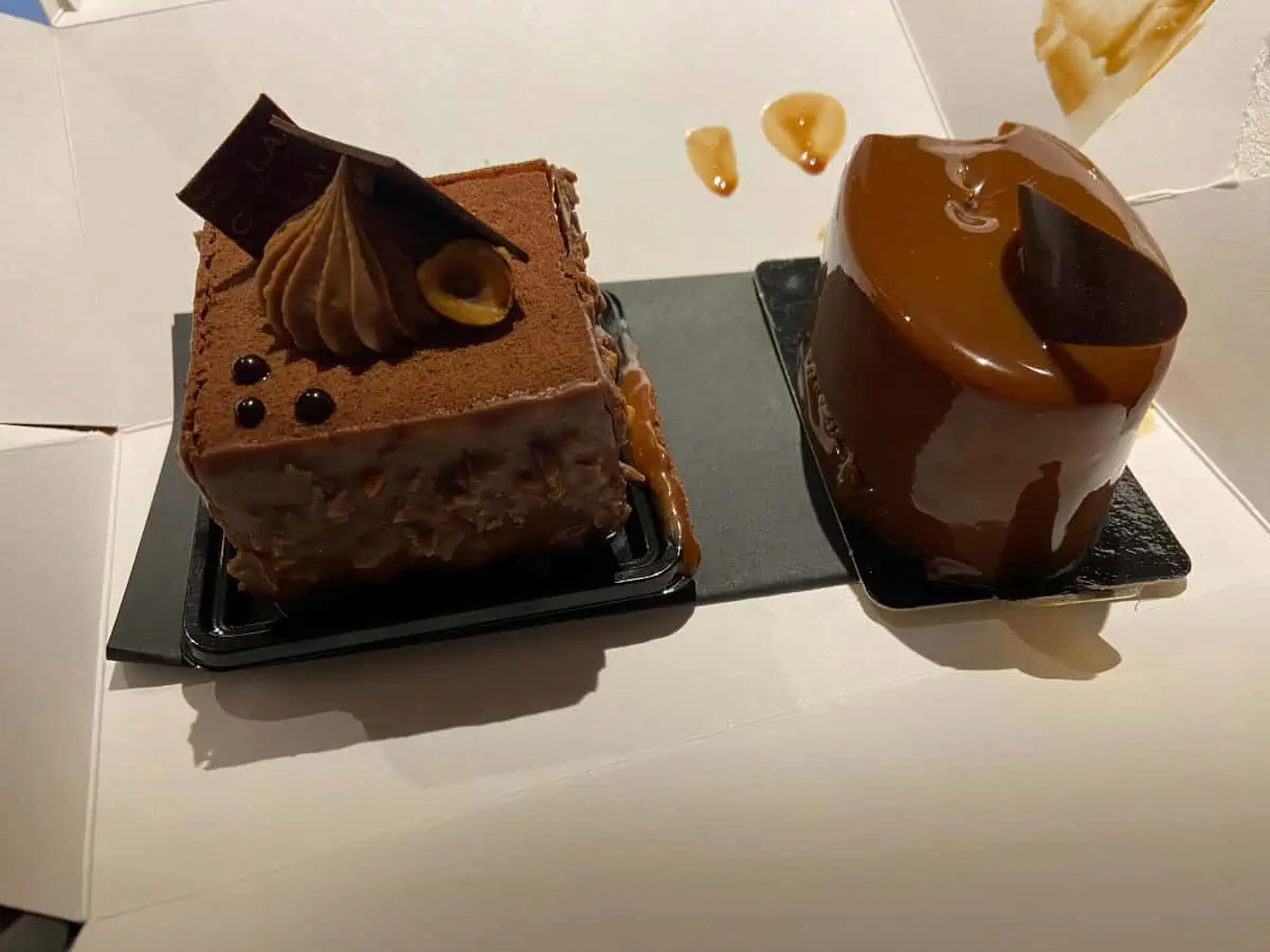 Two chocolate desserts in a white box