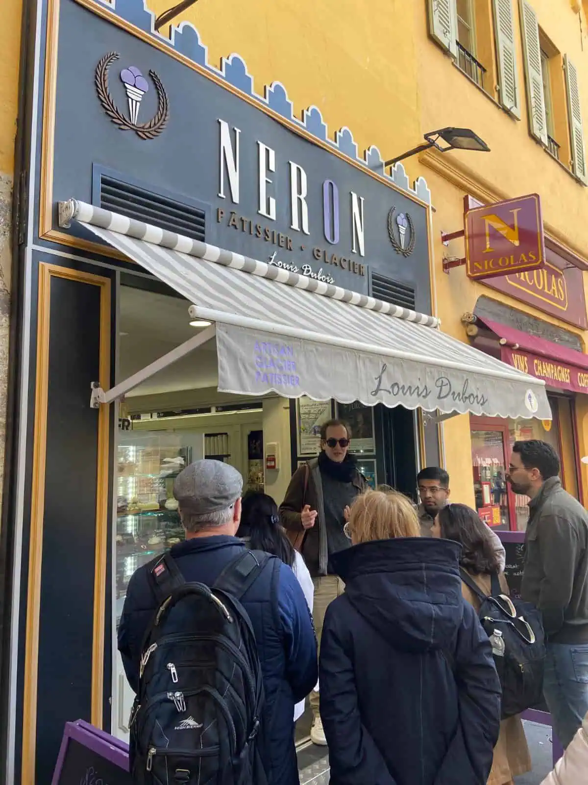 Standing in front of an ice cream shop with our food tour guide on a food tour in Nice, France