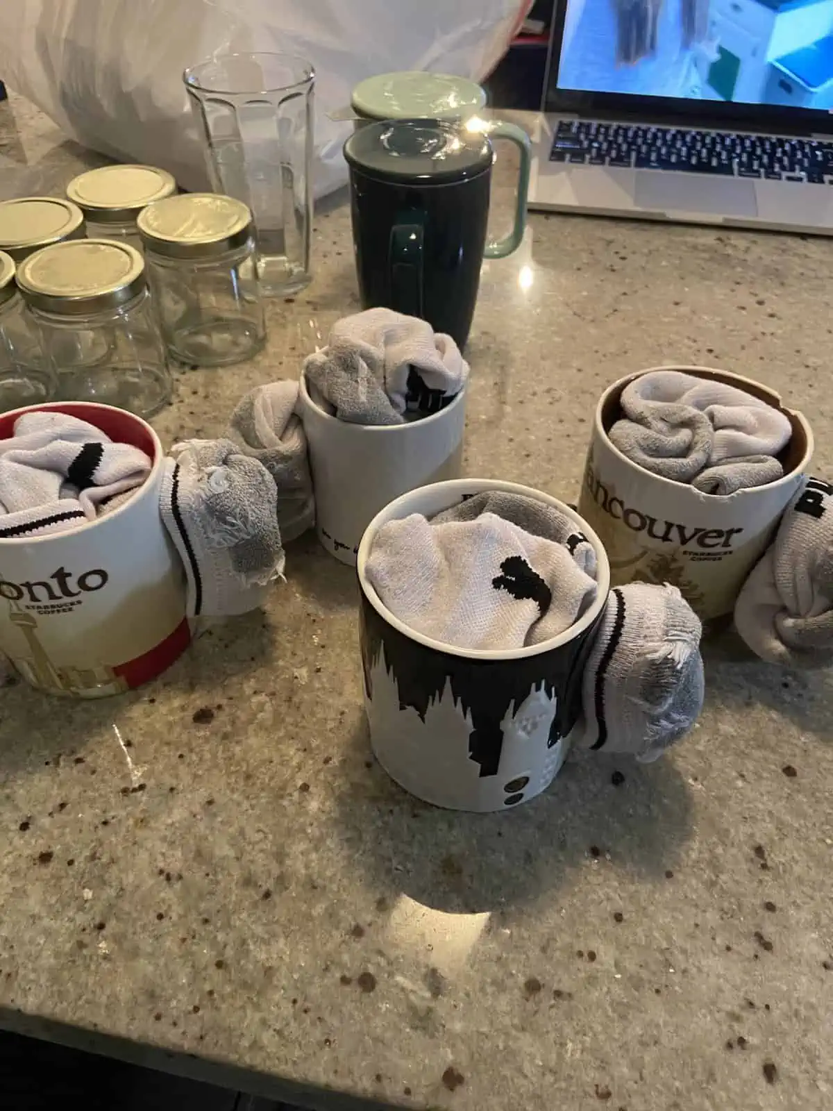 Socks wrapped around and inside mugs to protect them from breaking during a house move