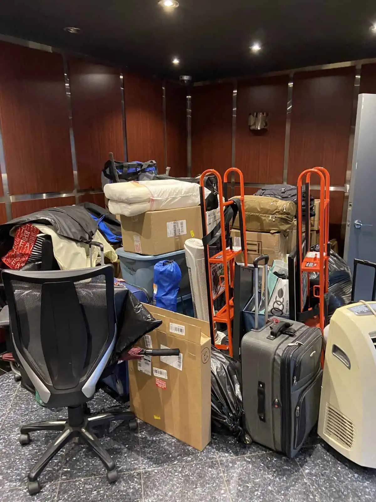 A hallway full of boxes, bins, chairs and dollies as we moved from one apartment to another