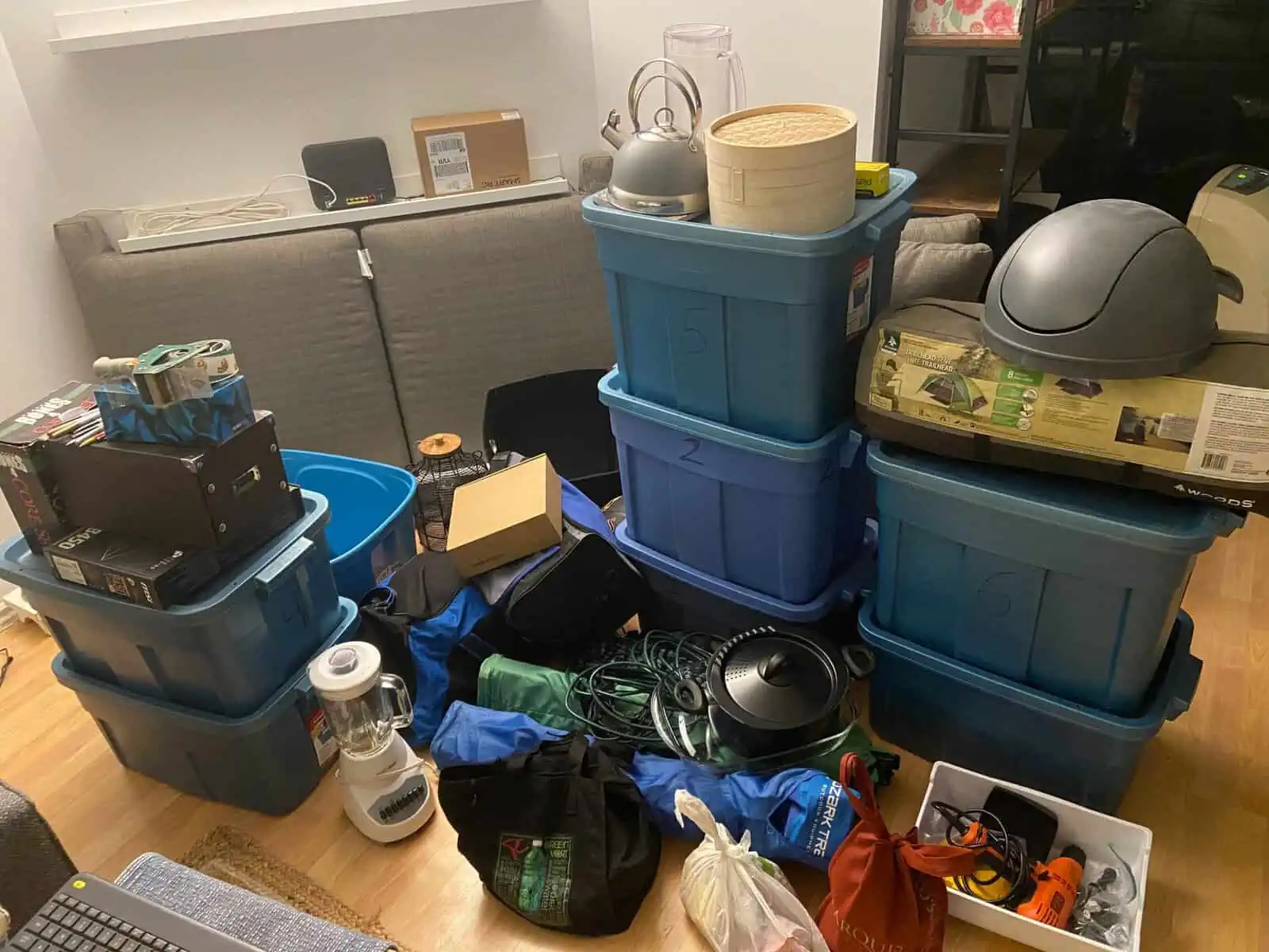 boxes and bins piled up in the living room for moving, packing and unpacking