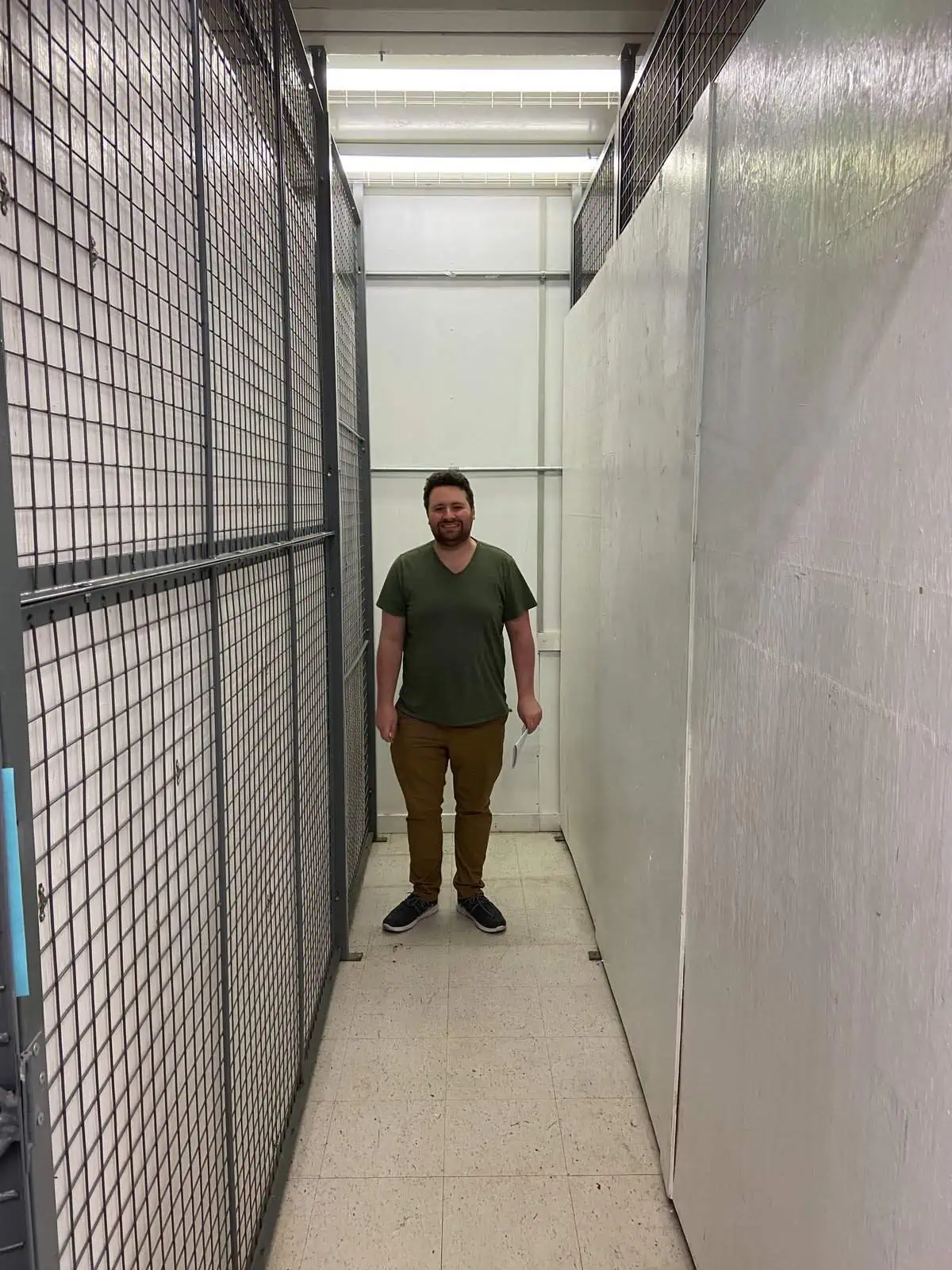 Colin standing in an empty storage locker for packing and moving