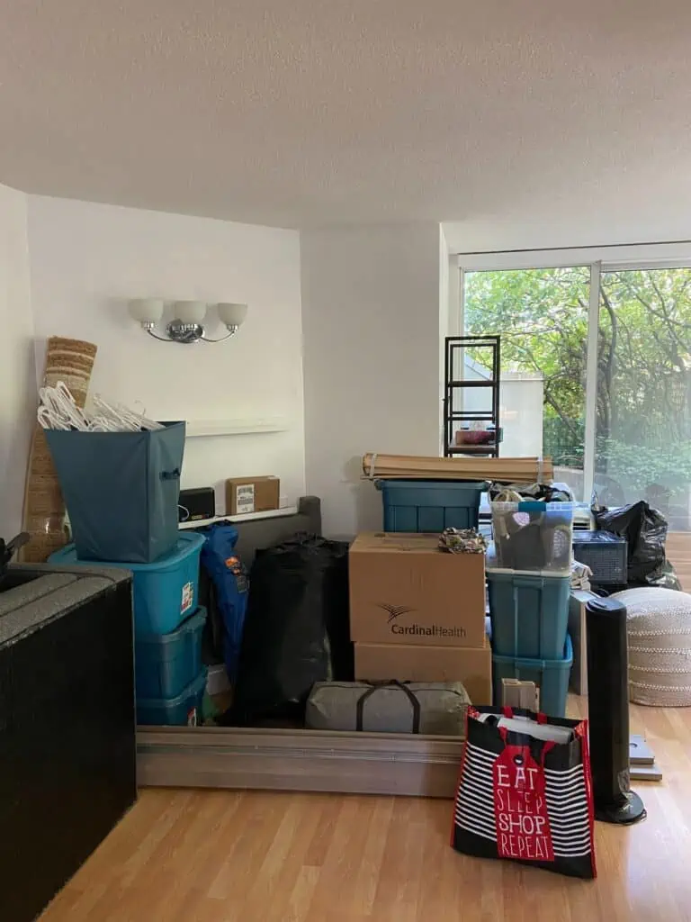 Living room full of boxes and storage bins during a house move