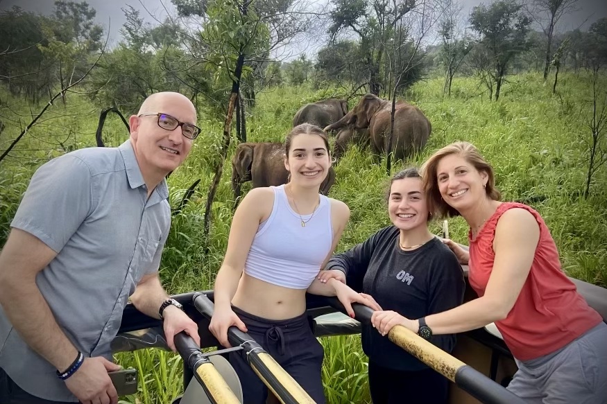 Travelers taking a photo with the elephants on a safari in Sri Lanka.