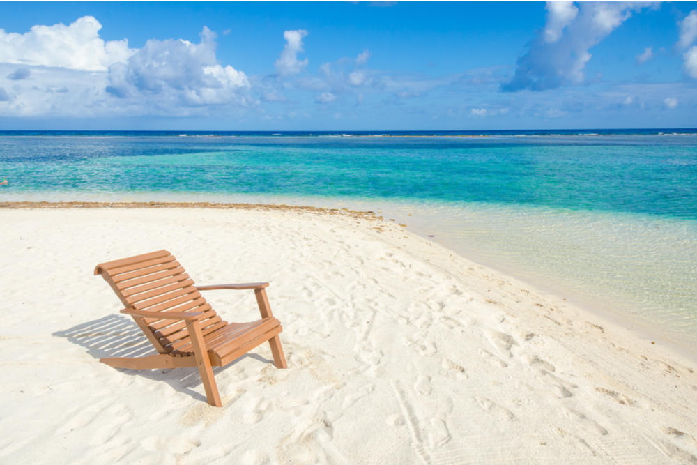 beach chair on sand and water Belize Cayes