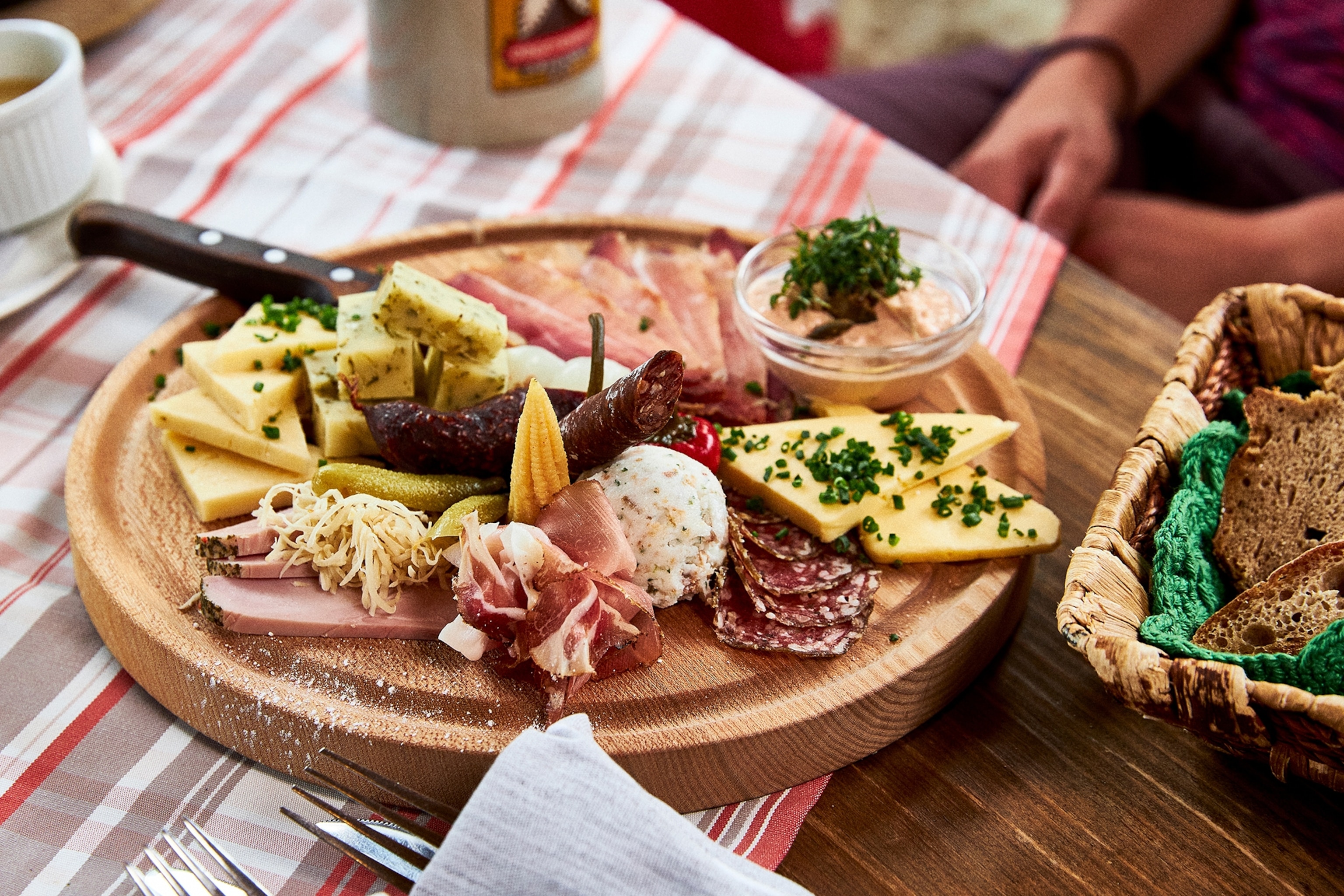 Close-up of a plated platter of cheese and cured meat.