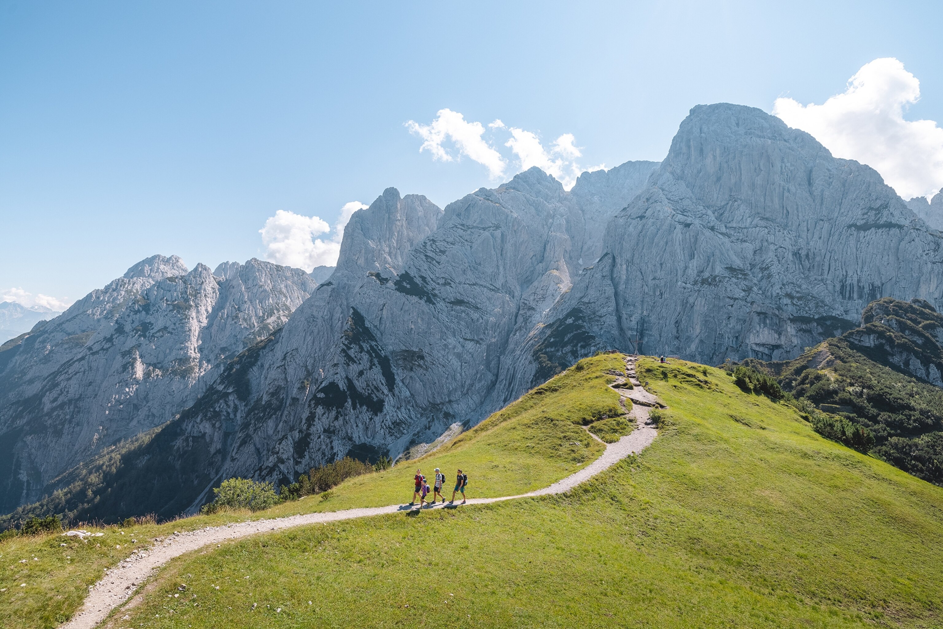 A wide shot of people on a mountain path.