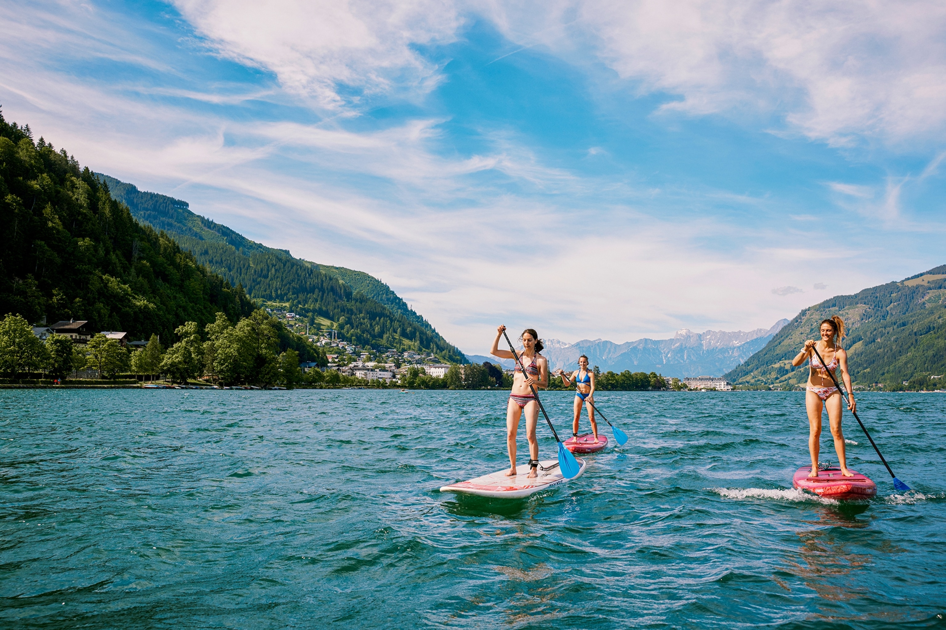 People paddleboarding on a lake.