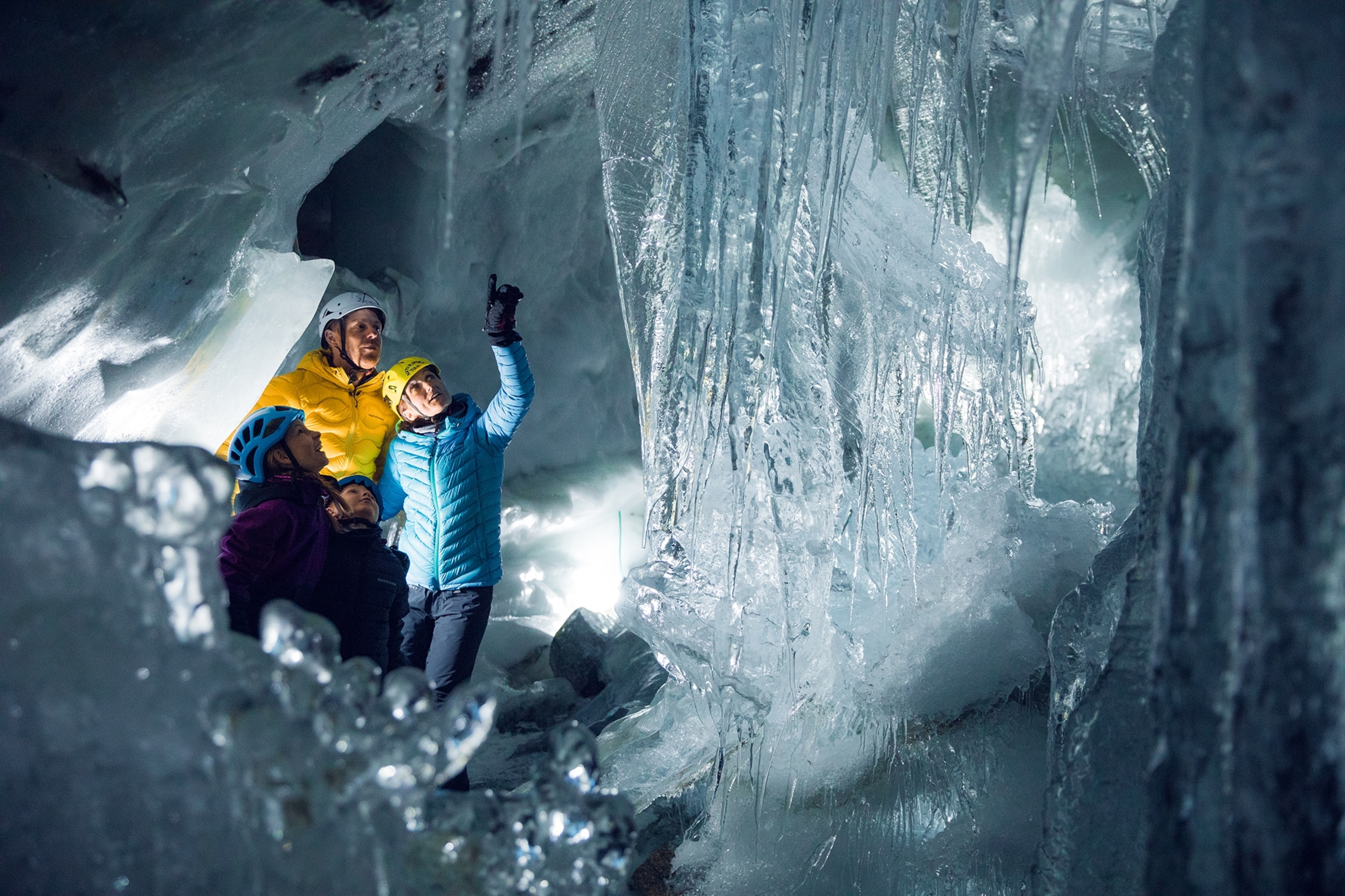 People exploring inside a glacier.