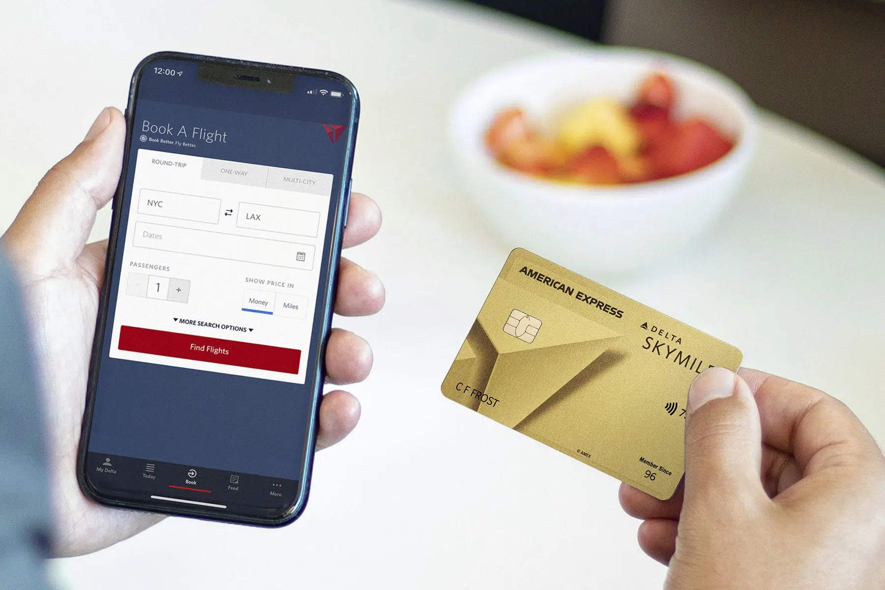 Delta SkyMiles Gold Card with phone showing the Delta app