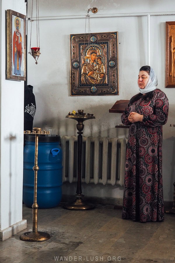 A woman prays inside a small church on Orthodox Epiphany in Georgia.