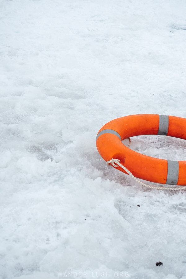 An orange life preserver on the icy surface of a frozen lake on the Javakheti Plateau in Georgia.