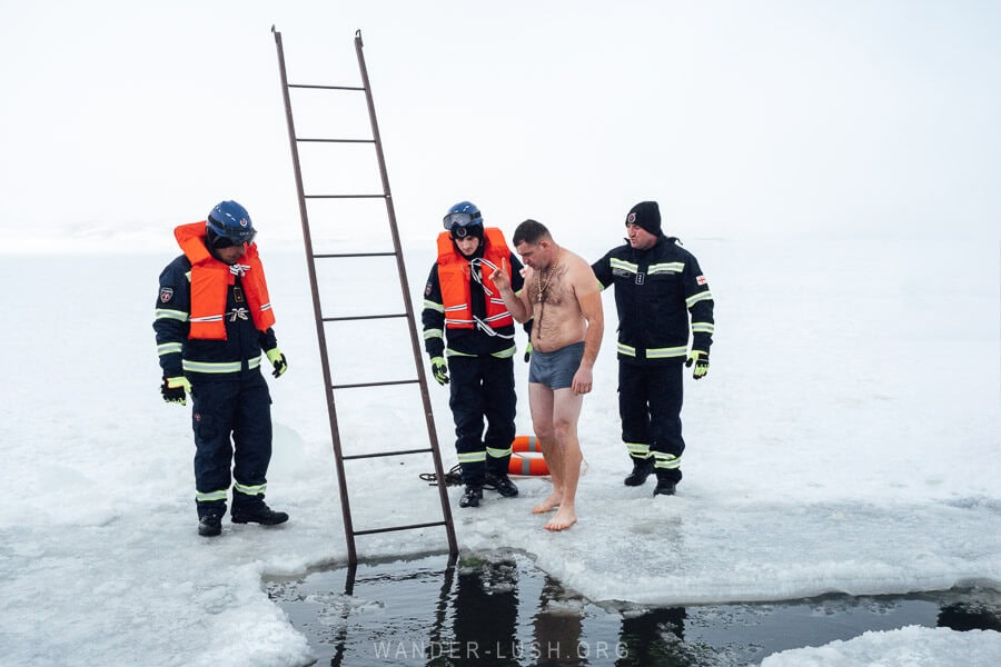 A man in briefs prepares to bath in ice water in Paravani Lake for Orthodox Epiphany.