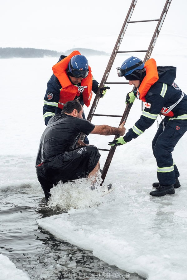 EMS workers assist a man to climb out of freezing lake water after he has performed an Orthodox Epiphany ritual in Georgia.