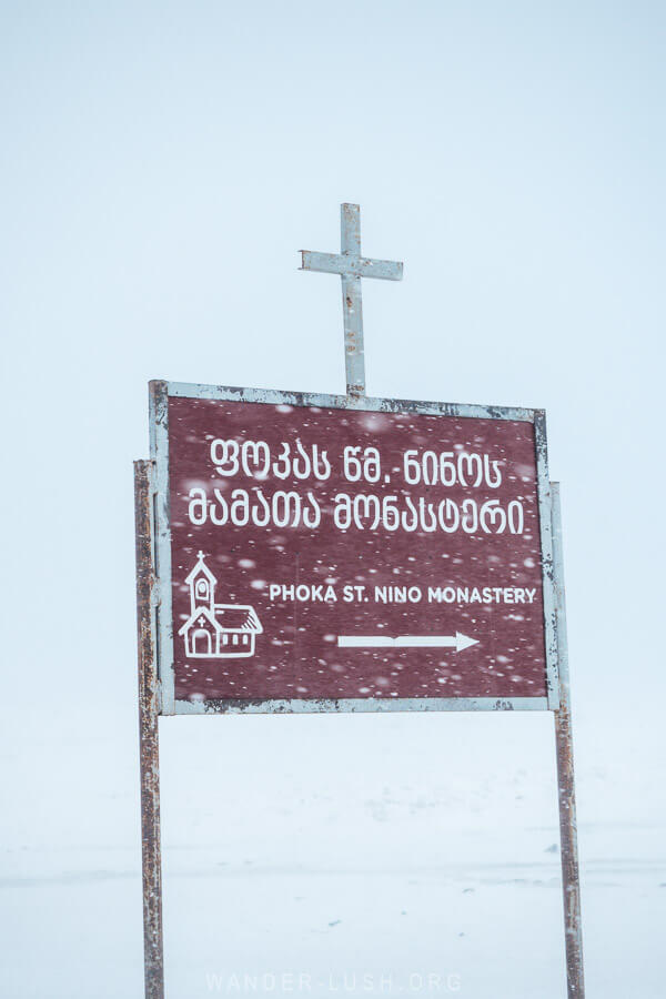 A brown sign points the way to Poka St Nino Monastery on the shore of Lake Paravani.