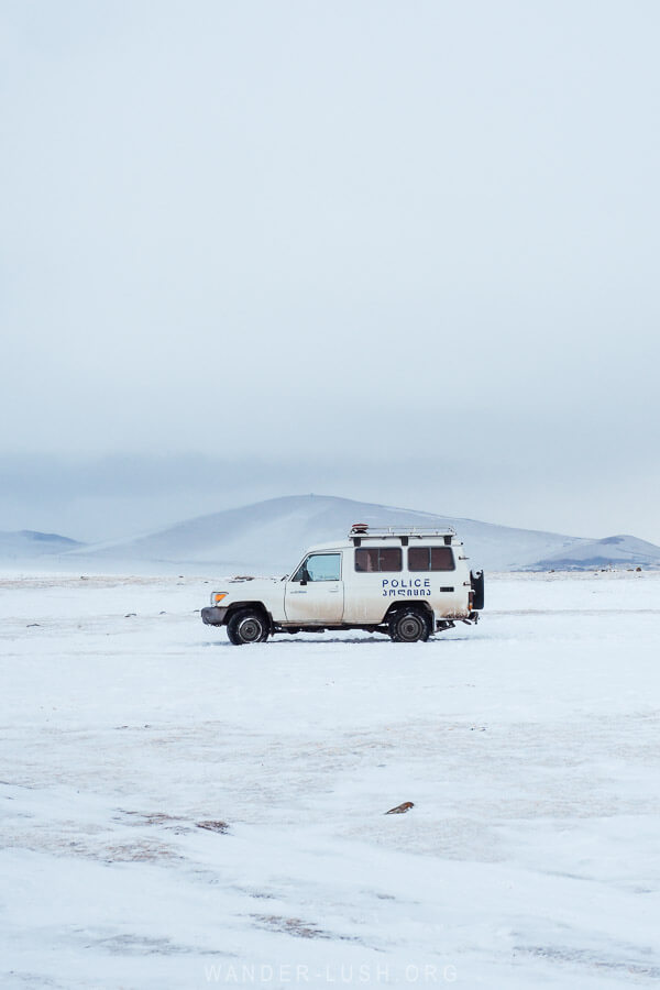 A police car parked on the ice in Georgia in winter.